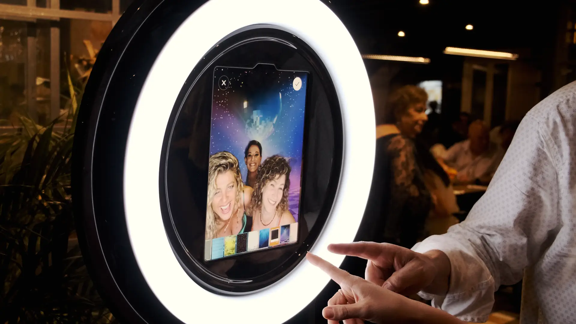 Pylon Parti-Pixel iPad photo booth with three girls posing and experimenting with the background filters