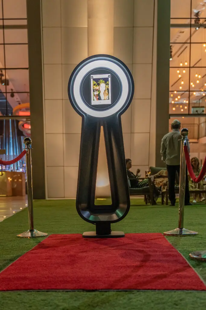 A photo of a woman displayed on a Parti-Pixel Photo Booth on a red carpet at an event