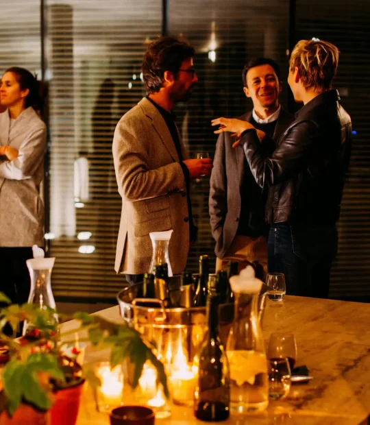 Two groups of people conversing at a corporate event